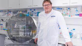 Prof. Stephan Urban in the laboratory; the Chris McGuigan Prize trophy is added to the left of the picture.