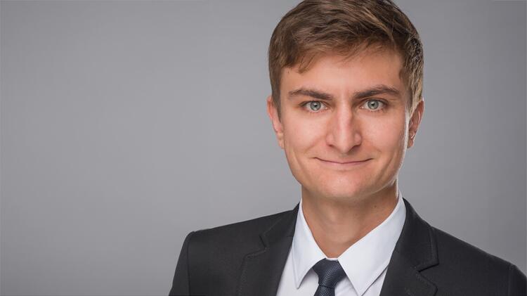 Portrait of Dr. Janko Sattler. Mr Sattler is wearing a dark suit and tie.
